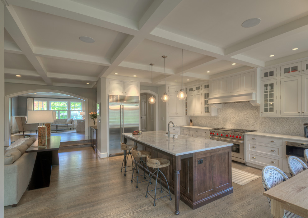 Example of a large transitional l-shaped light wood floor open concept kitchen design in DC Metro with a farmhouse sink, recessed-panel cabinets, white cabinets, quartzite countertops, stainless steel appliances and an island