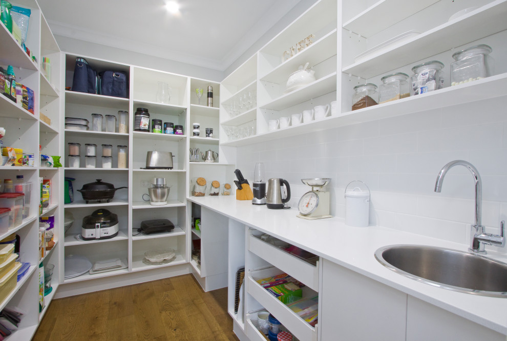 Inspiration for a large contemporary kitchen pantry in Sunshine Coast with a submerged sink, shaker cabinets, white cabinets, quartz worktops, mosaic tiled splashback, stainless steel appliances and an island.