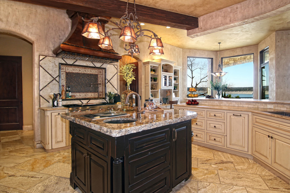 Design ideas for a large mediterranean kitchen in Austin with raised-panel cabinets, beige cabinets, granite worktops, stainless steel appliances, porcelain flooring, an island, a submerged sink, multi-coloured splashback and beige floors.