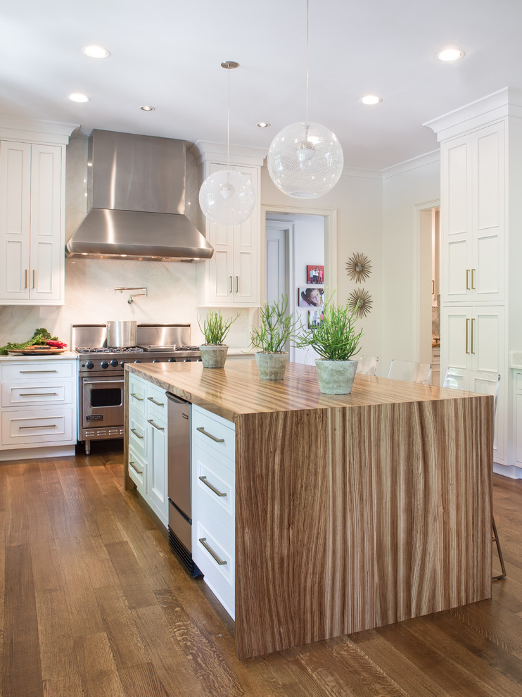 Eat-in kitchen - large transitional l-shaped medium tone wood floor and brown floor eat-in kitchen idea in Philadelphia with beaded inset cabinets, white cabinets, wood countertops, white backsplash, stainless steel appliances, an island, a farmhouse sink and stone slab backsplash