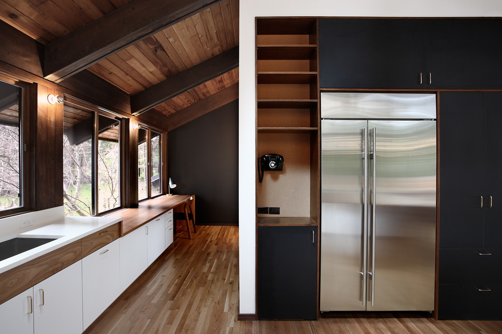 Example of a mid-century modern kitchen design in Seattle