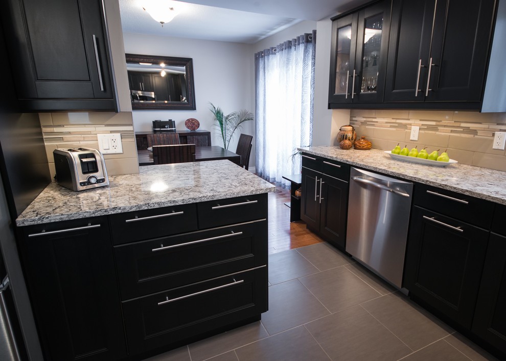 Classic u-shaped kitchen/diner in Ottawa with a submerged sink, shaker cabinets, black cabinets, engineered stone countertops, grey splashback, porcelain splashback and stainless steel appliances.