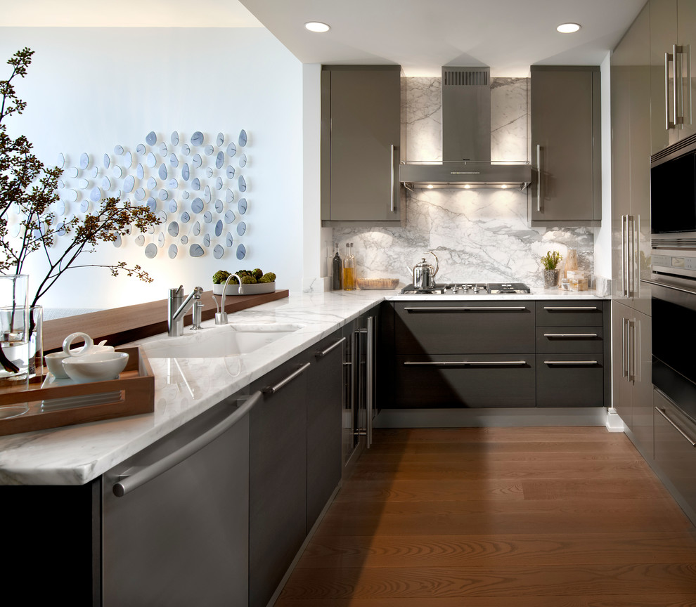 Photo of a contemporary u-shaped kitchen/diner in Chicago with flat-panel cabinets, white splashback, stainless steel appliances, dark hardwood flooring, a submerged sink, brown cabinets and stone slab splashback.