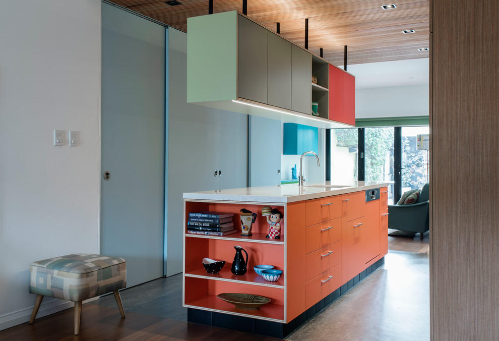 This is an example of a medium sized contemporary galley kitchen pantry in Sydney with a single-bowl sink, flat-panel cabinets, orange cabinets, terrazzo worktops, stainless steel appliances, lino flooring and an island.