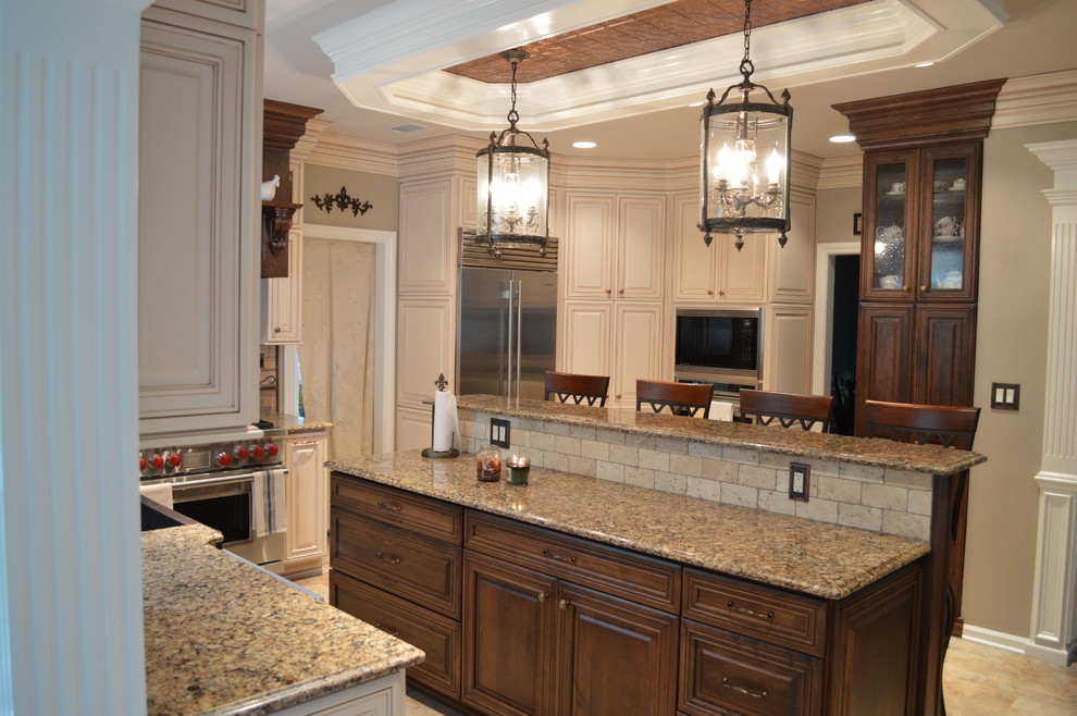 Example of a large classic u-shaped ceramic tile and beige floor eat-in kitchen design in Newark with a farmhouse sink, raised-panel cabinets, light wood cabinets, quartz countertops, beige backsplash, stone tile backsplash, stainless steel appliances and an island