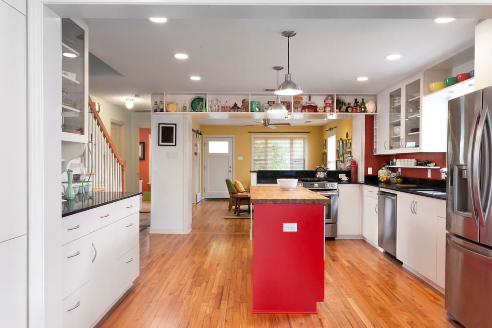 Large transitional l-shaped light wood floor eat-in kitchen photo in Austin with an undermount sink, flat-panel cabinets, white cabinets, quartz countertops, red backsplash, stainless steel appliances and two islands