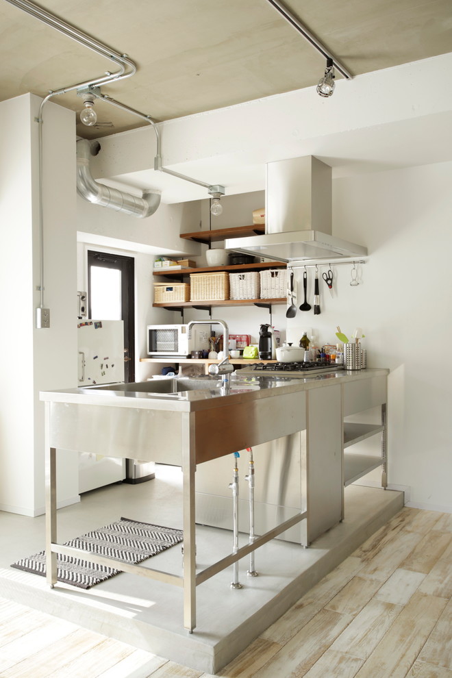 Example of a small urban kitchen design in Tokyo with an integrated sink, open cabinets and an island