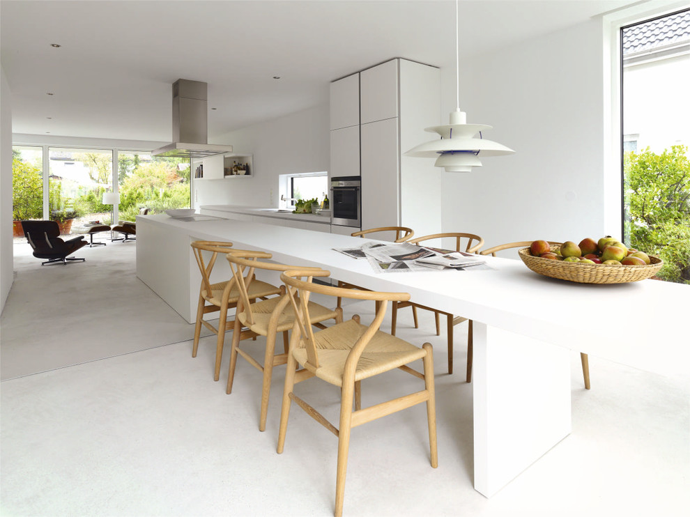 Photo of a large scandinavian single-wall kitchen/diner in Gothenburg with flat-panel cabinets, white cabinets, laminate countertops, stainless steel appliances, concrete flooring and an island.