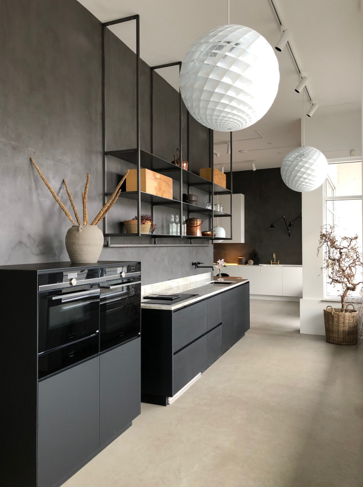 Medium sized contemporary l-shaped kitchen in Malmo with flat-panel cabinets, engineered stone countertops, black appliances, concrete flooring, no island, grey floors, beige worktops, a submerged sink and black splashback.