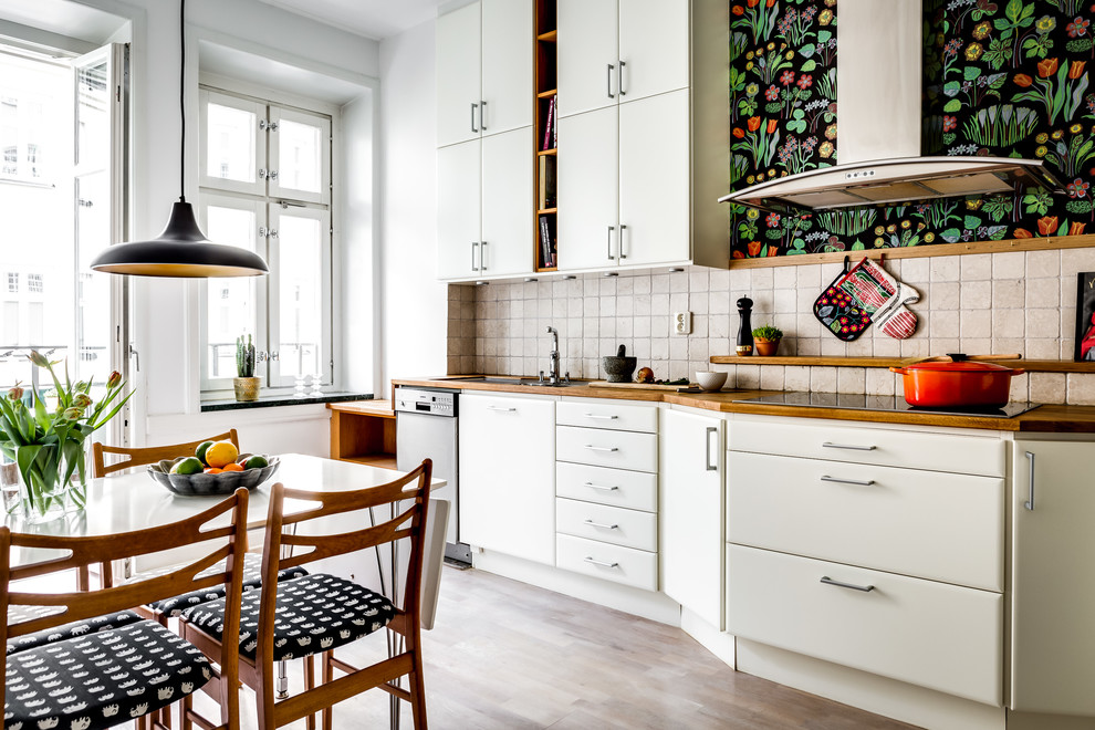 Einzeilige, Mittelgroße Nordische Küche ohne Insel mit flächenbündigen Schrankfronten, weißen Schränken, Küchenrückwand in Beige und Tapete in Stockholm