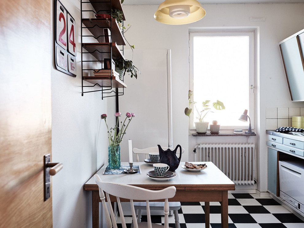 Small danish single-wall ceramic tile eat-in kitchen photo in Stockholm with flat-panel cabinets, blue cabinets and no island