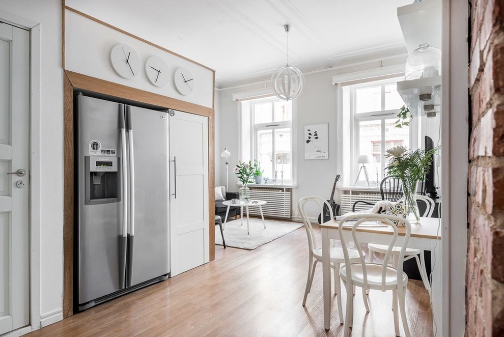 Mid-sized danish open concept kitchen photo in Gothenburg with flat-panel cabinets, white cabinets, stainless steel appliances and no island