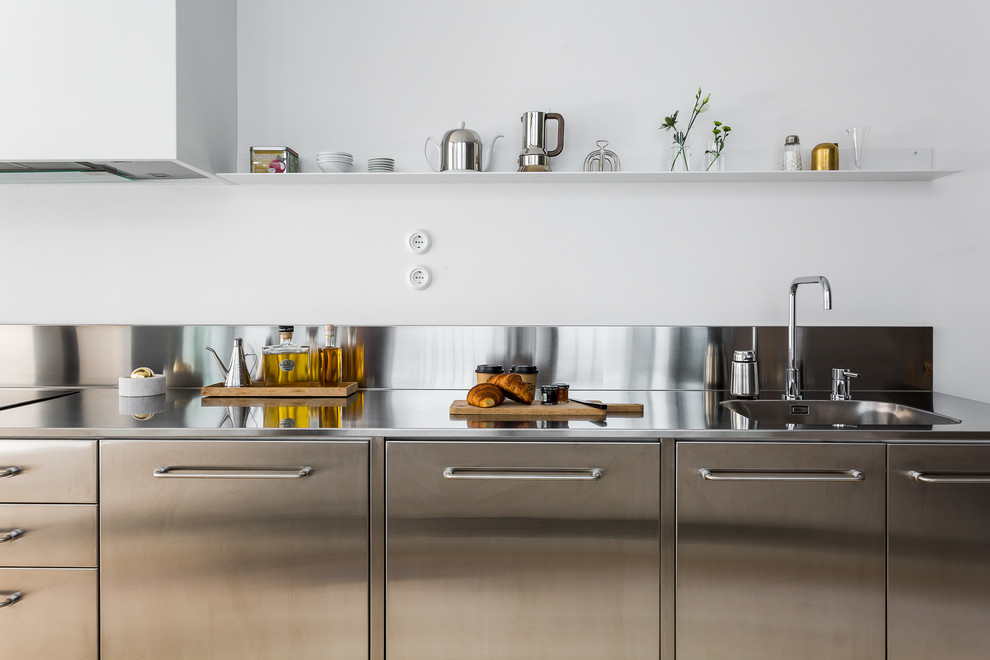 This is an example of an urban kitchen in Stockholm with stainless steel worktops.