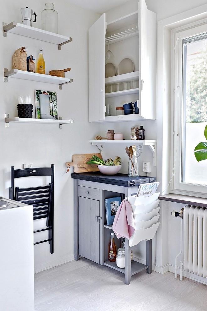 This is an example of a small scandinavian open plan kitchen in Stockholm.
