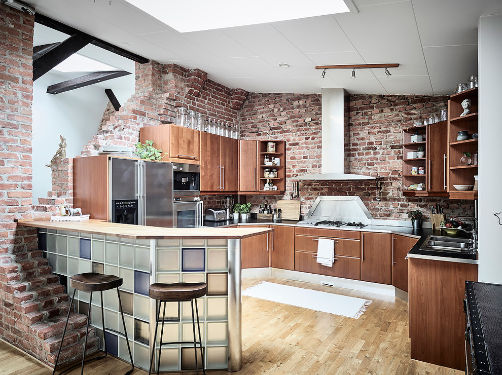 Photo of a rustic kitchen in Gothenburg with flat-panel cabinets, brown cabinets, red splashback, brick splashback, medium hardwood flooring, an island and brown floors.