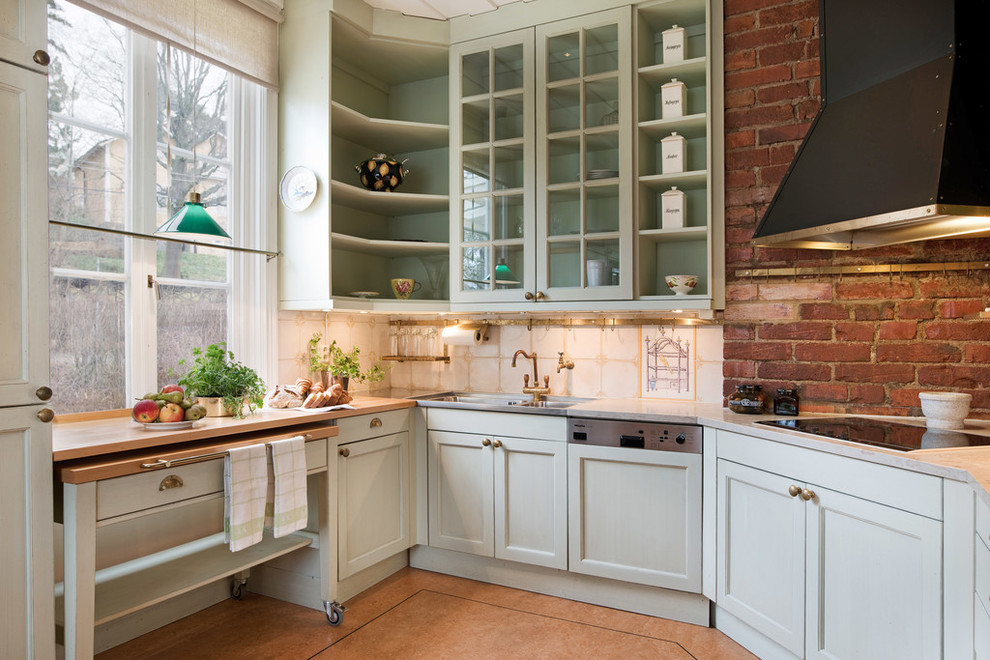 Enclosed kitchen - mid-sized farmhouse single-wall enclosed kitchen idea in Stockholm with a double-bowl sink, glass-front cabinets, green cabinets, marble countertops and no island