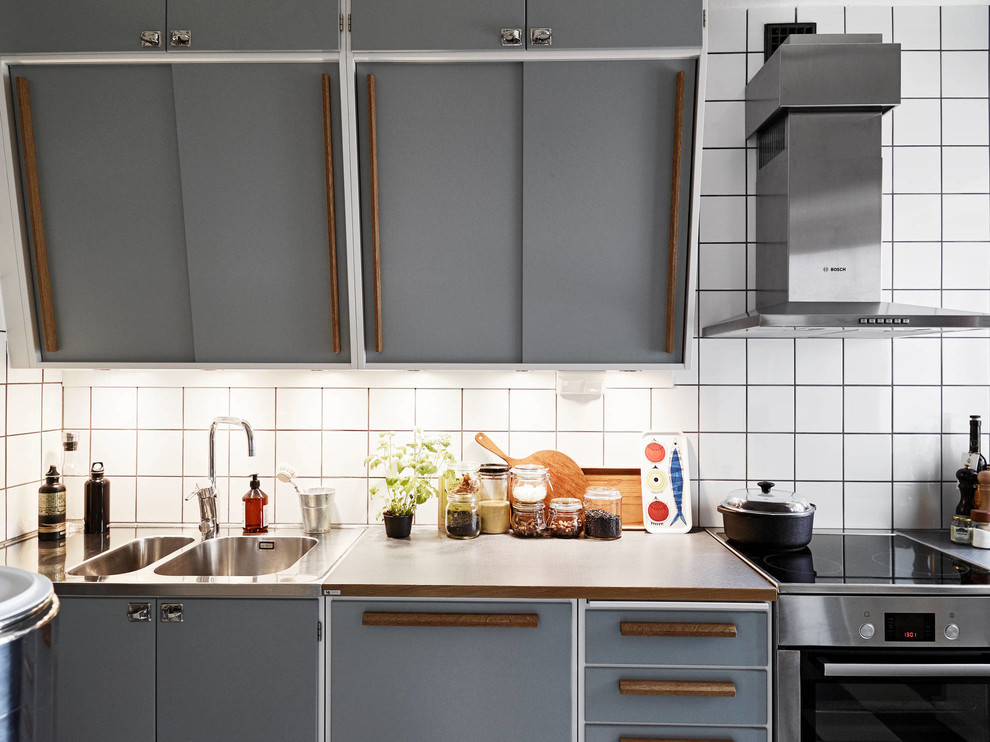 Photo of a small midcentury single-wall kitchen in Other with flat-panel cabinets, grey cabinets, wood worktops, stainless steel appliances and no island.