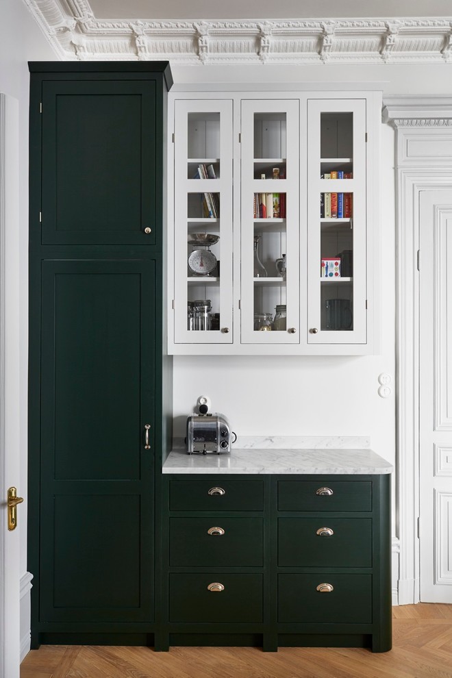 This is an example of a victorian kitchen/diner in Stockholm with marble worktops and grey splashback.