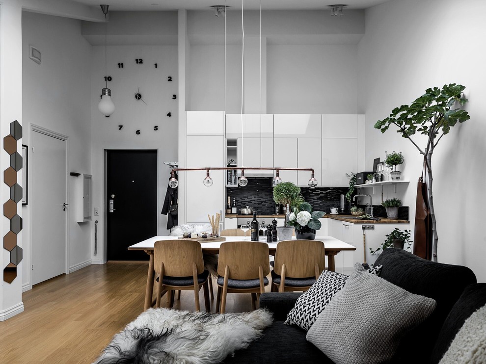 Photo of a medium sized scandinavian single-wall kitchen/diner in Stockholm with flat-panel cabinets, white cabinets, wood worktops, medium hardwood flooring and no island.