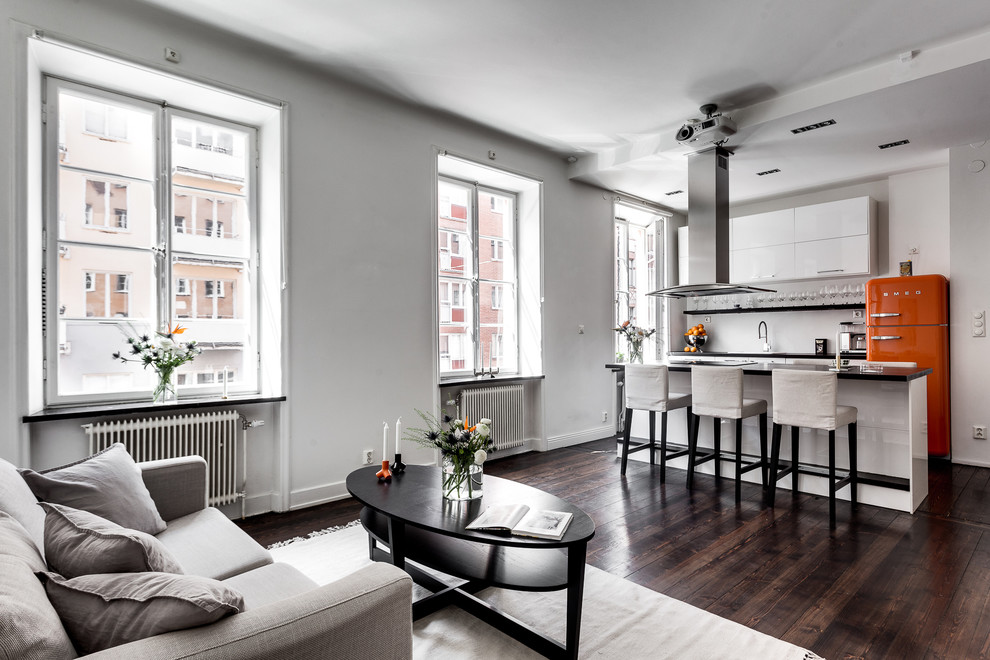 This is an example of a medium sized scandinavian kitchen in Stockholm with dark hardwood flooring.