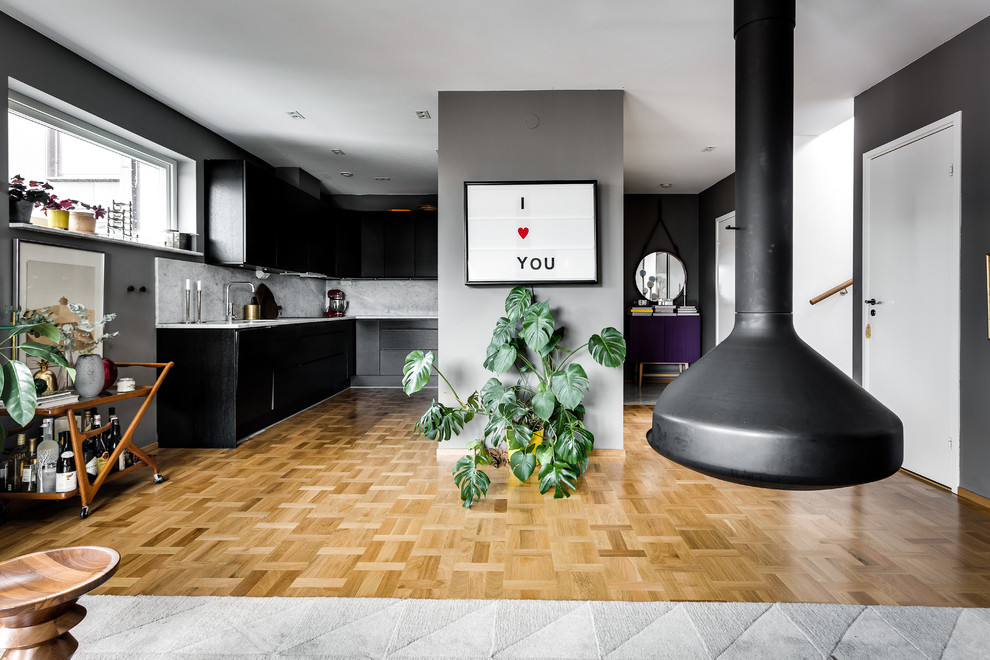 Immagine di una grande cucina scandinava con lavello da incasso, ante lisce, top in marmo, paraspruzzi grigio, pavimento in legno massello medio e nessuna isola