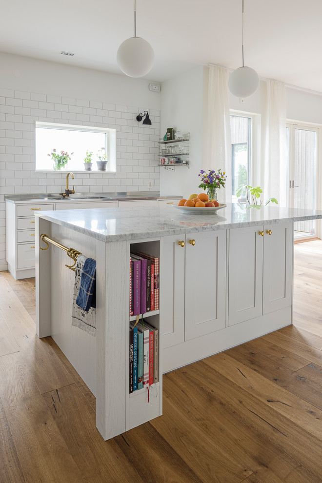 Inspiration for a large transitional u-shaped dark wood floor eat-in kitchen remodel in Gothenburg with a double-bowl sink, shaker cabinets, gray cabinets, marble countertops, stainless steel appliances and an island