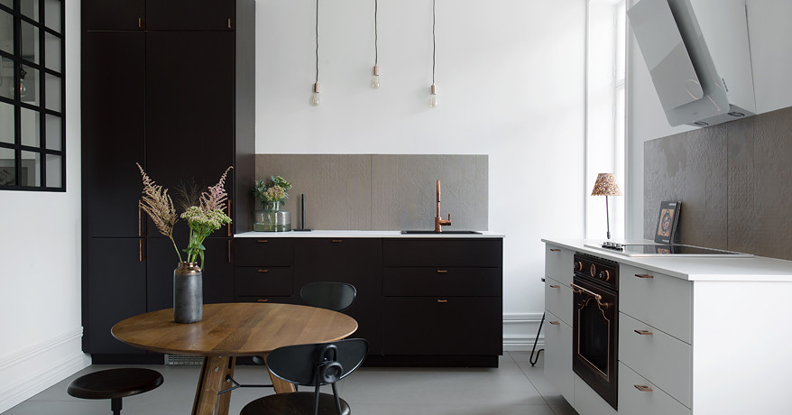 Medium sized urban l-shaped open plan kitchen in Stockholm with a single-bowl sink, flat-panel cabinets, blue cabinets, beige splashback, black appliances, light hardwood flooring, no island and white worktops.