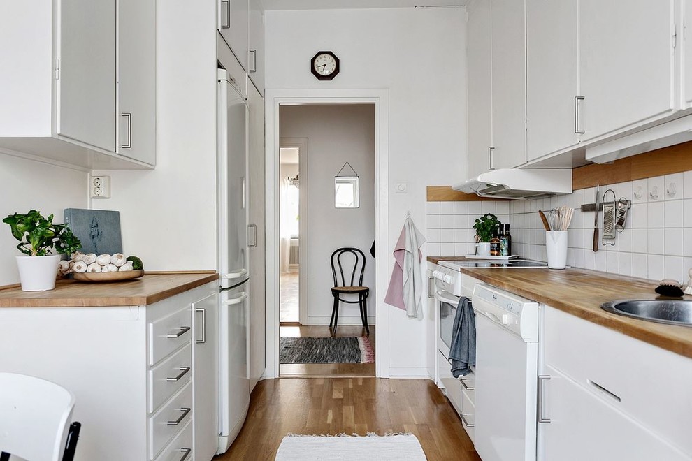 Inspiration for a scandi galley kitchen/diner with wood worktops.