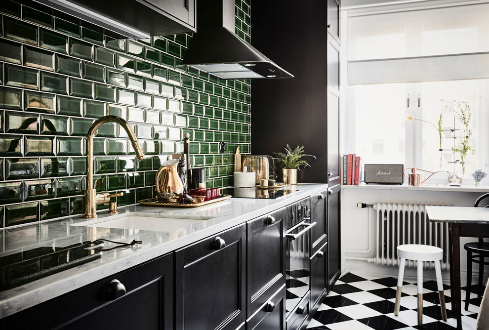 Bohemian single-wall kitchen/diner in Gothenburg with a single-bowl sink, shaker cabinets, black cabinets, marble worktops, green splashback, ceramic splashback, stainless steel appliances, no island and multi-coloured floors.