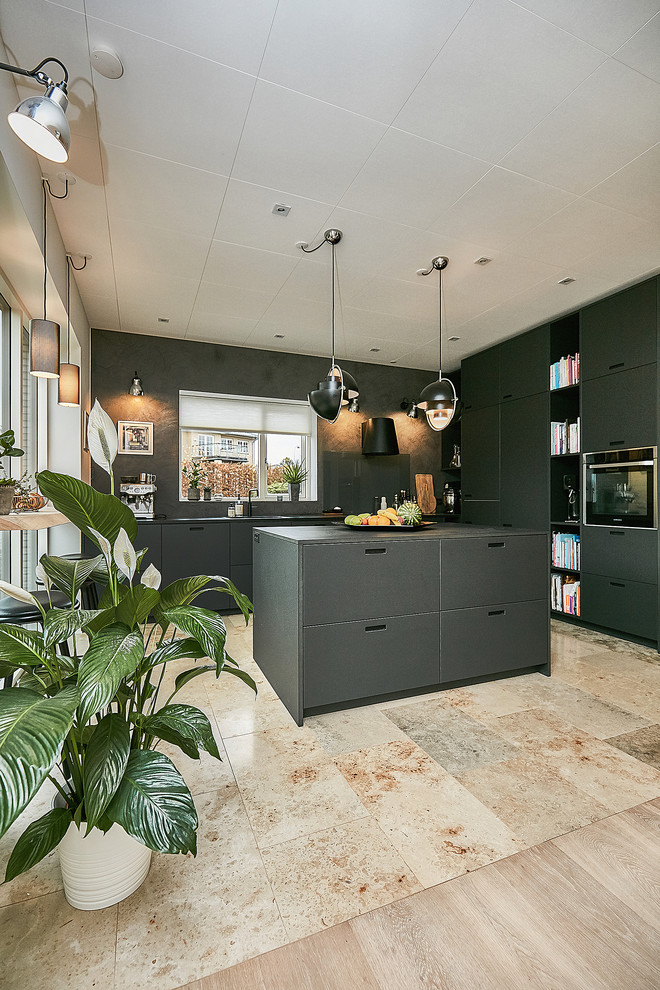 Contemporary open plan kitchen in Copenhagen with flat-panel cabinets, black cabinets and marble flooring.