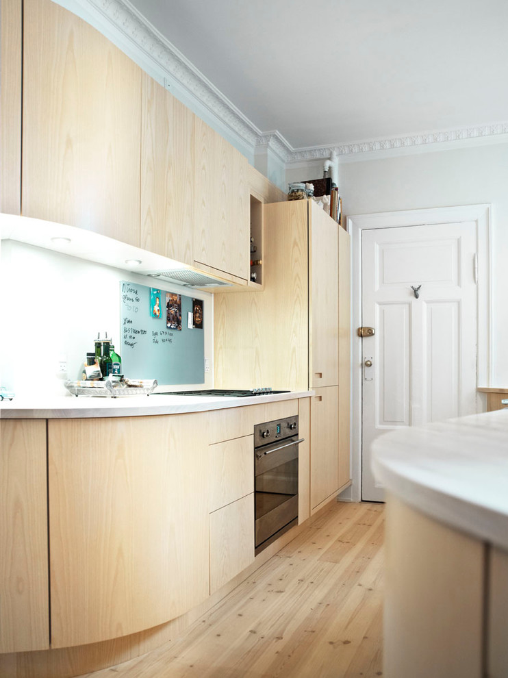 Design ideas for a scandi kitchen in Copenhagen with glass sheet splashback.