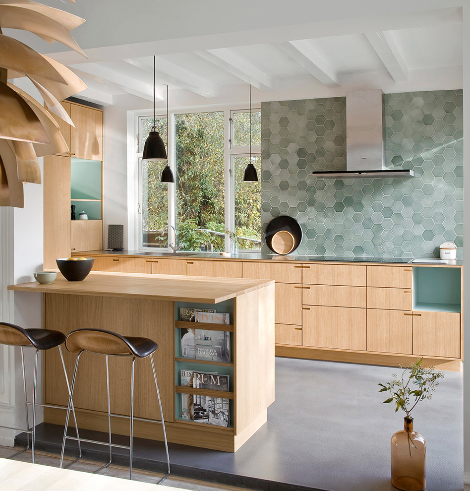 Inspiration for a medium sized scandi galley kitchen/diner in Copenhagen with flat-panel cabinets, light wood cabinets, green splashback, mosaic tiled splashback, a breakfast bar, an integrated sink, wood worktops and lino flooring.