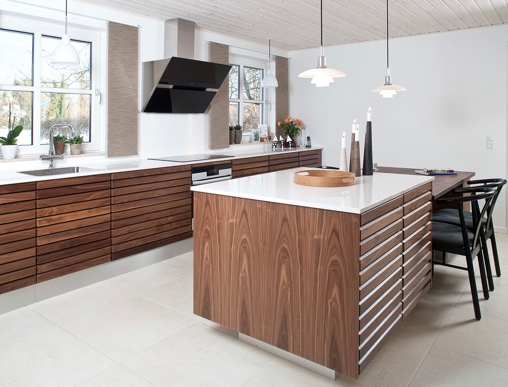 Modern kitchen/diner in Aalborg with beaded cabinets, medium wood cabinets, quartz worktops, white splashback, an island and white floors.