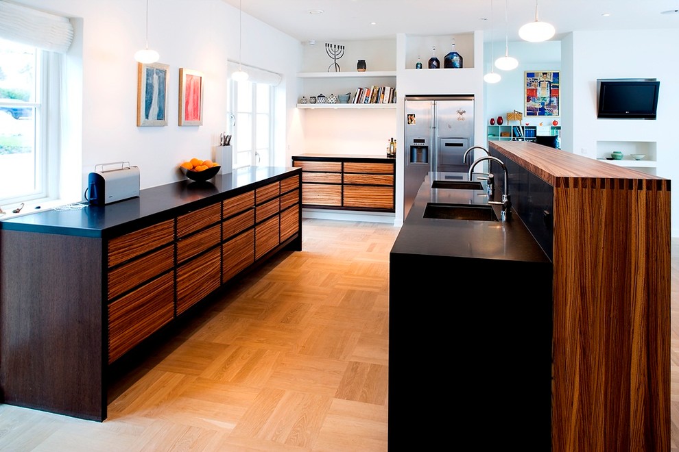 Example of a large danish beige floor kitchen design in Copenhagen with a double-bowl sink