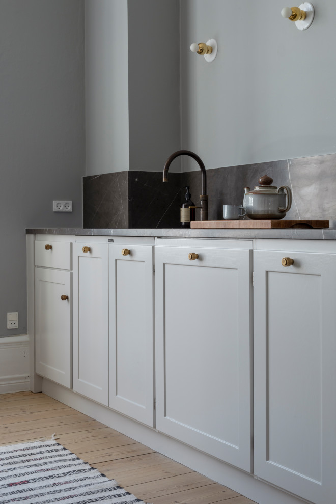 Inspiration for a medium sized modern single-wall open plan kitchen in Copenhagen with an island.