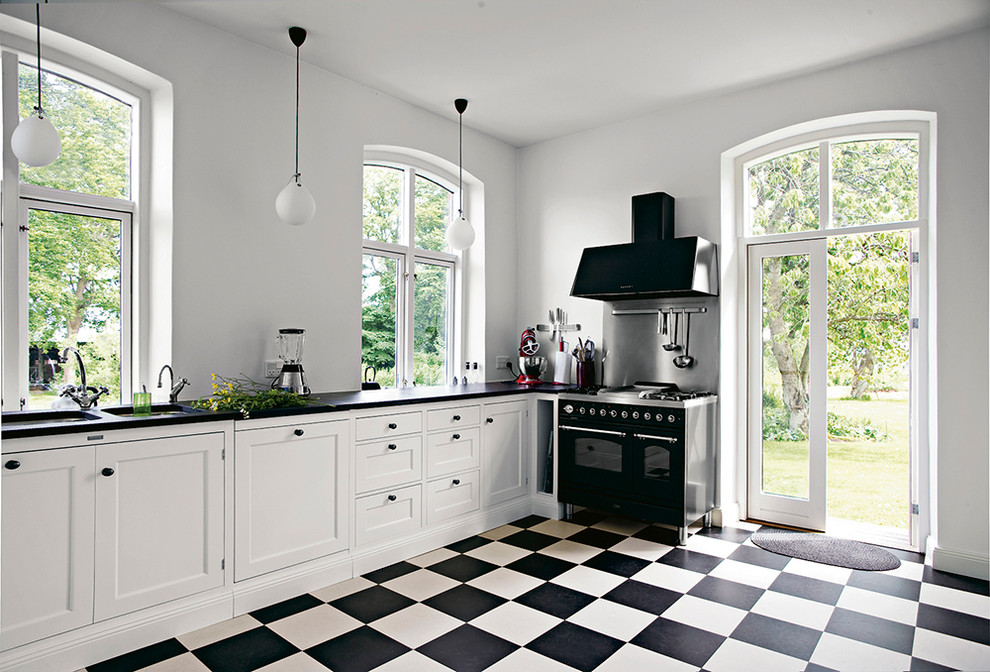 Large scandi kitchen in Copenhagen with lino flooring and multi-coloured floors.