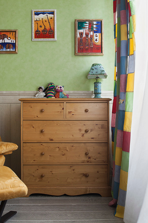 Photo of a medium sized contemporary nursery for boys in Moscow with multi-coloured walls and dark hardwood flooring.