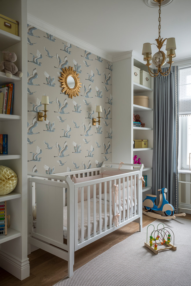 Inspiration for a traditional gender neutral nursery in Moscow with beige walls, medium hardwood flooring and brown floors.