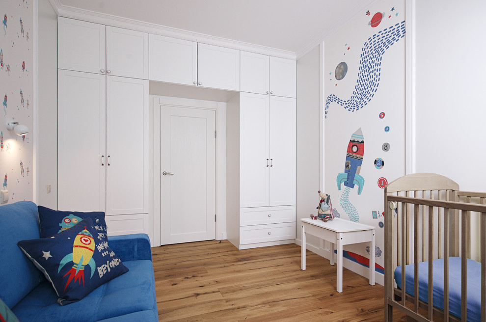 Imagen de habitación de bebé niño tradicional renovada con paredes multicolor y suelo de madera en tonos medios