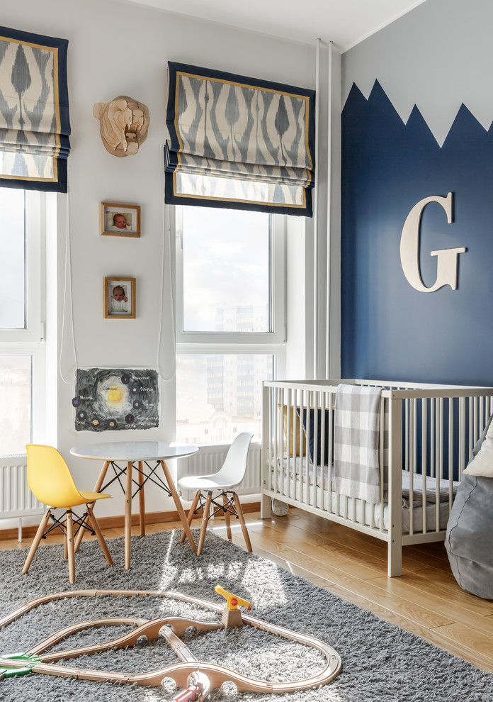 Neutrales Skandinavisches Babyzimmer mit blauer Wandfarbe, braunem Holzboden und braunem Boden in Moskau