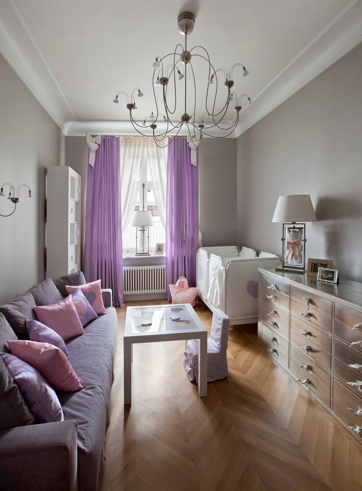 Design ideas for a contemporary nursery for girls in Moscow with grey walls and light hardwood flooring.