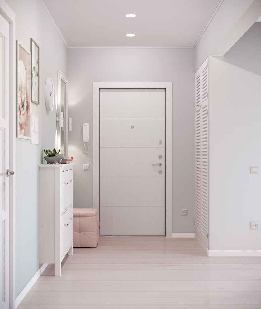 Example of a mid-sized danish laminate floor and beige floor hallway design in Other with white walls