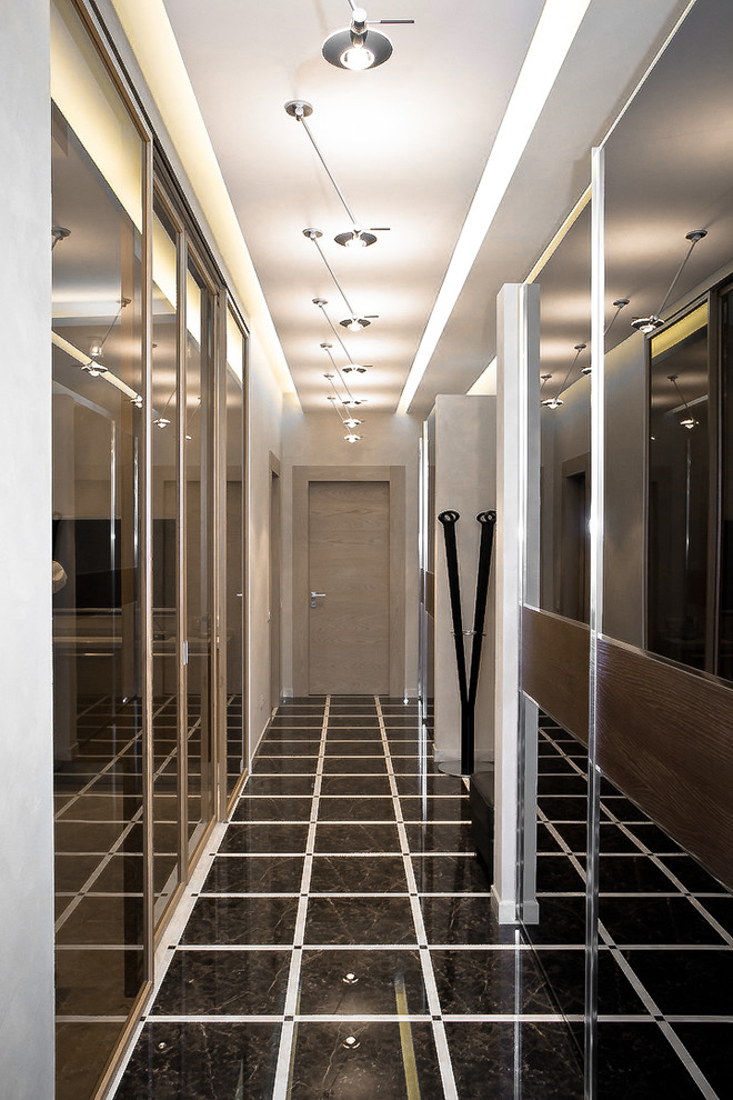 Стильный дизайн: узкий коридор среднего размера в современном стиле с серыми стенами, полом из керамогранита и коричневым полом - последний тренд