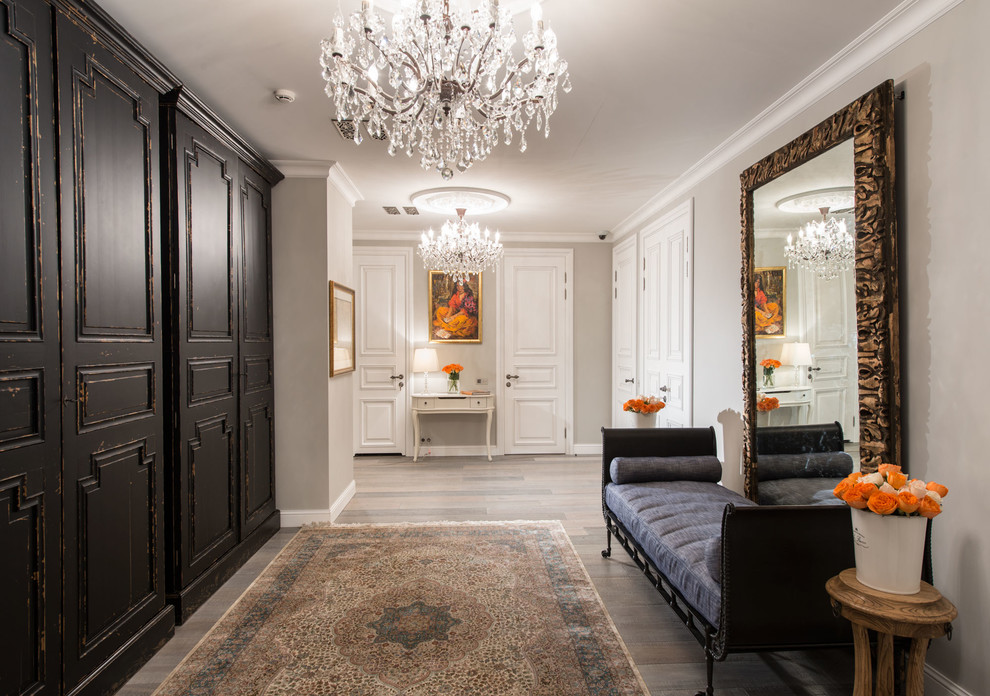 Inspiration for a timeless medium tone wood floor hallway remodel in Moscow with gray walls