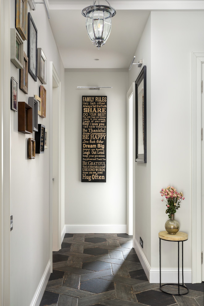 Hallway - traditional black floor hallway idea in Moscow with white walls