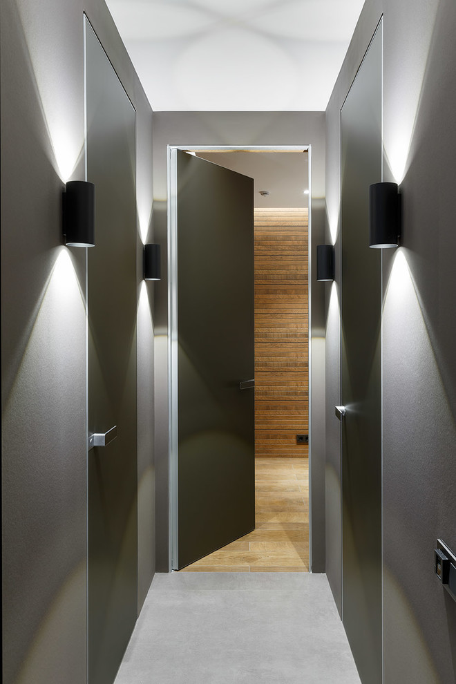 Idées déco pour un petit couloir contemporain avec un sol en carrelage de porcelaine et un mur gris.
