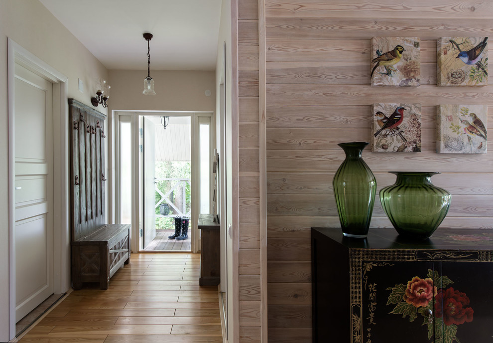 Inspiration for a mid-sized eclectic medium tone wood floor hallway remodel in Moscow with beige walls