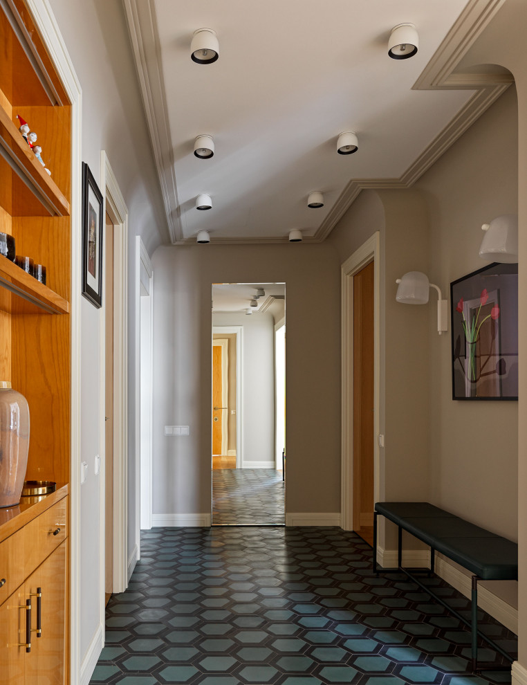 На фото: коридор в стиле неоклассика (современная классика) с серыми стенами, бирюзовым полом и многоуровневым потолком с