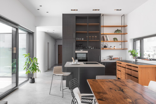 Modern Bright Kitchen with Black Full-height Cabinets