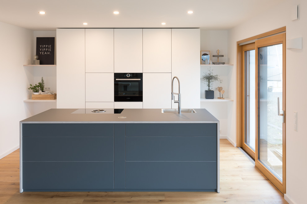 Idee per una cucina moderna di medie dimensioni con ante lisce, ante bianche, top in laminato, top blu, lavello da incasso, pavimento in legno massello medio e pavimento marrone